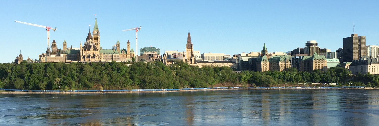 View of the Ottawa River, Parliament Hill, and buildings in downtown Ottawa.